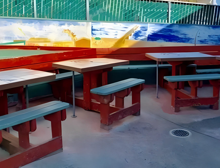Outdoor seating area with colorful painted mural.